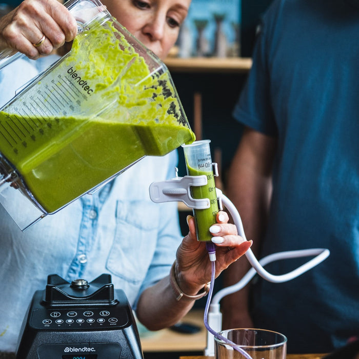 Carrie gießt pürierte Lebensmittel in eine Sonde